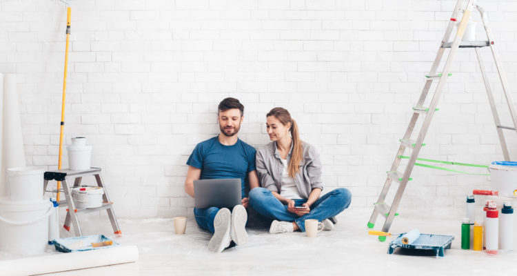 Young couple using laptop during home improvement